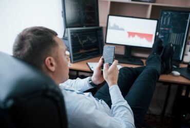 Business owner. Man working online in the office with multiple computer screens in index charts