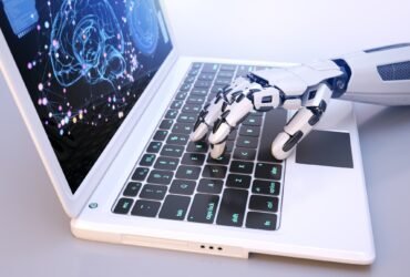 Robot's hand typing on keyboard