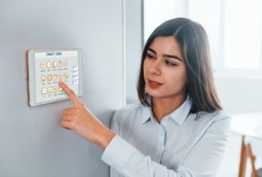 Woman is indoors controlling smart home technology